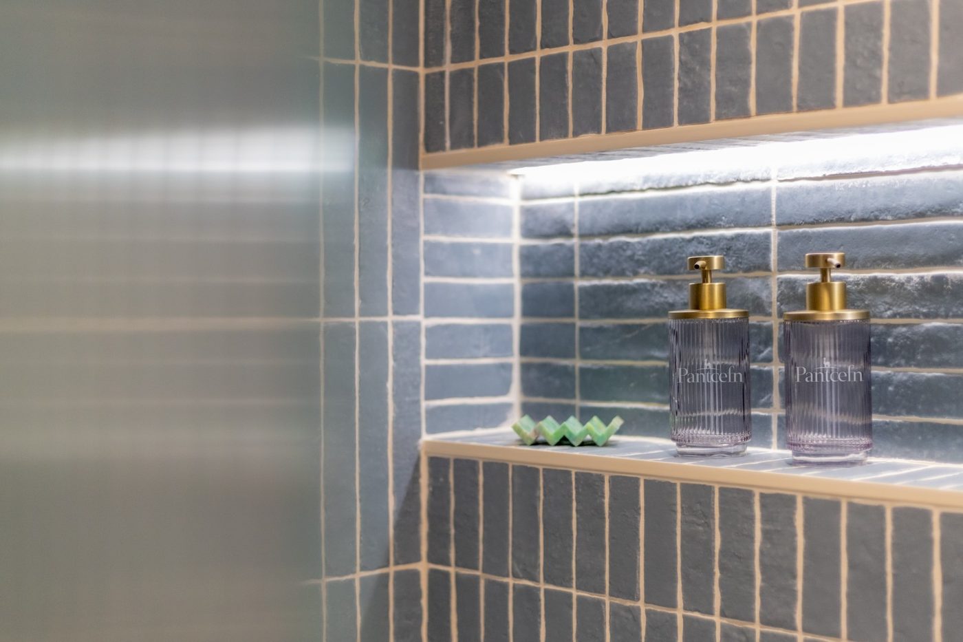 Pantcefn branded toiletries in the Tri-Pod shower niche