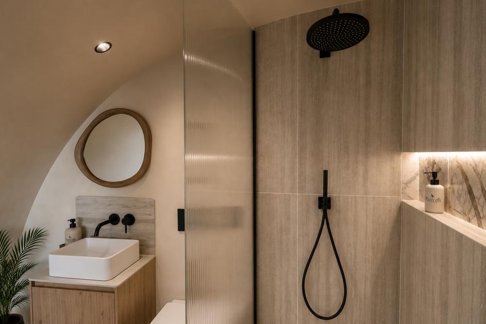 Marble bathroom with black rainfall shower and floating vessel sink