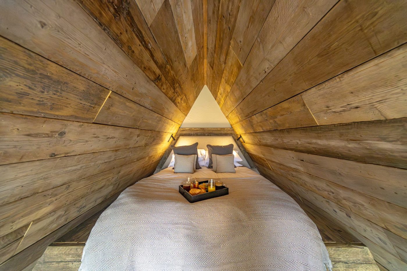King-size bed nestled in the timber apex of the Tri-Pod mezzanine