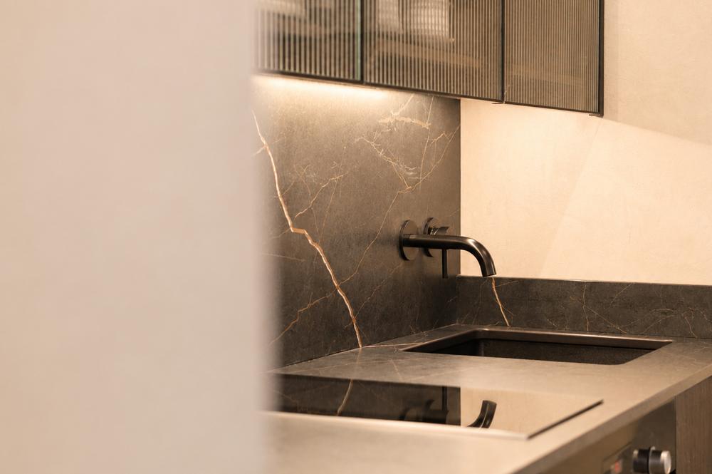 Marble kitchen worktop with integrated induction hob and black fittings
