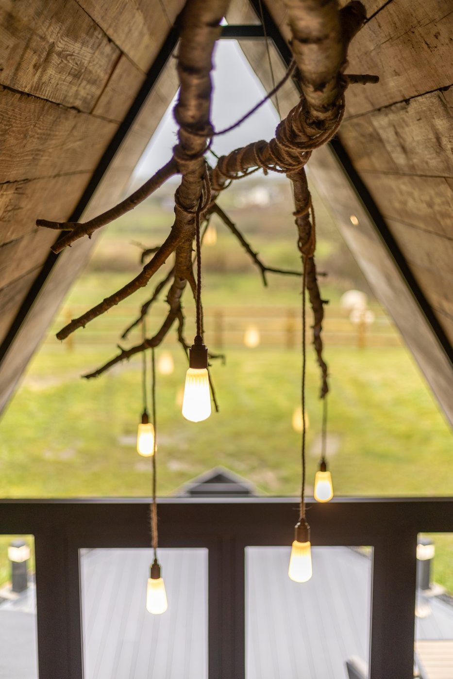 Handmade branch chandelier in the Tri-Pod gable window — Edison bulbs and rope