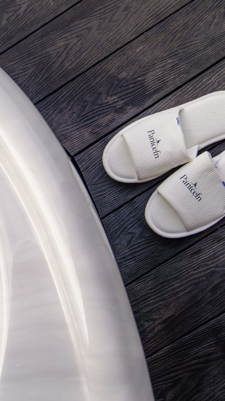 Pantcefn branded slippers beside the hot tub on the Piglet Pod deck