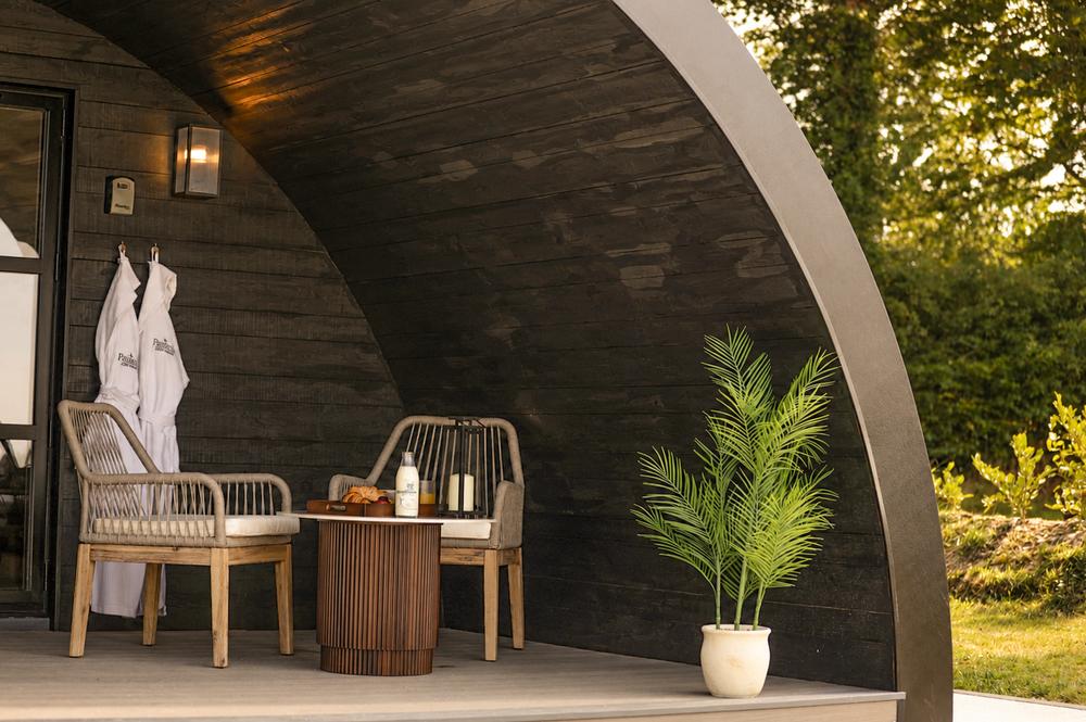 Deck seating with robes, palm and lantern by day
